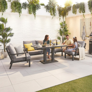 Family sitting together on grey sofa